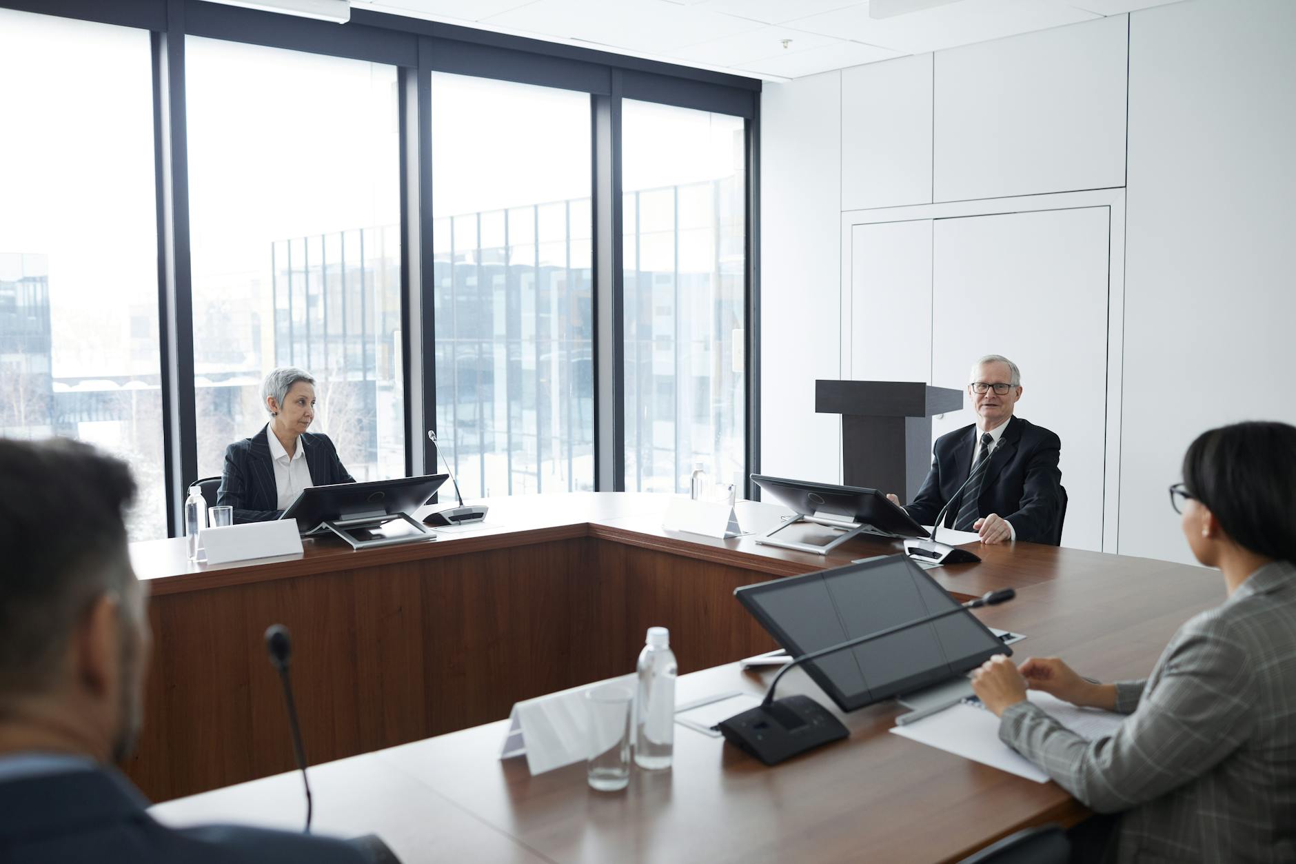 Business professionals discussing technology strategy in modern office environment