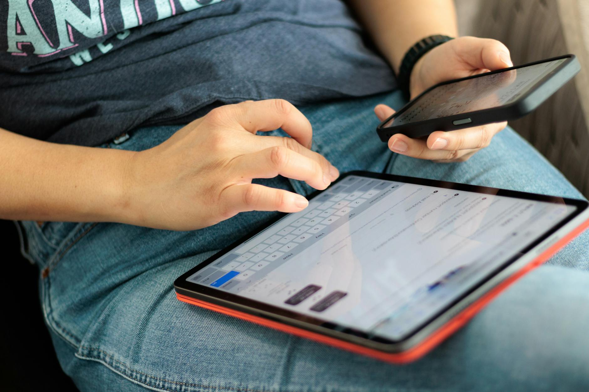 Person holding tablet device with both hands
