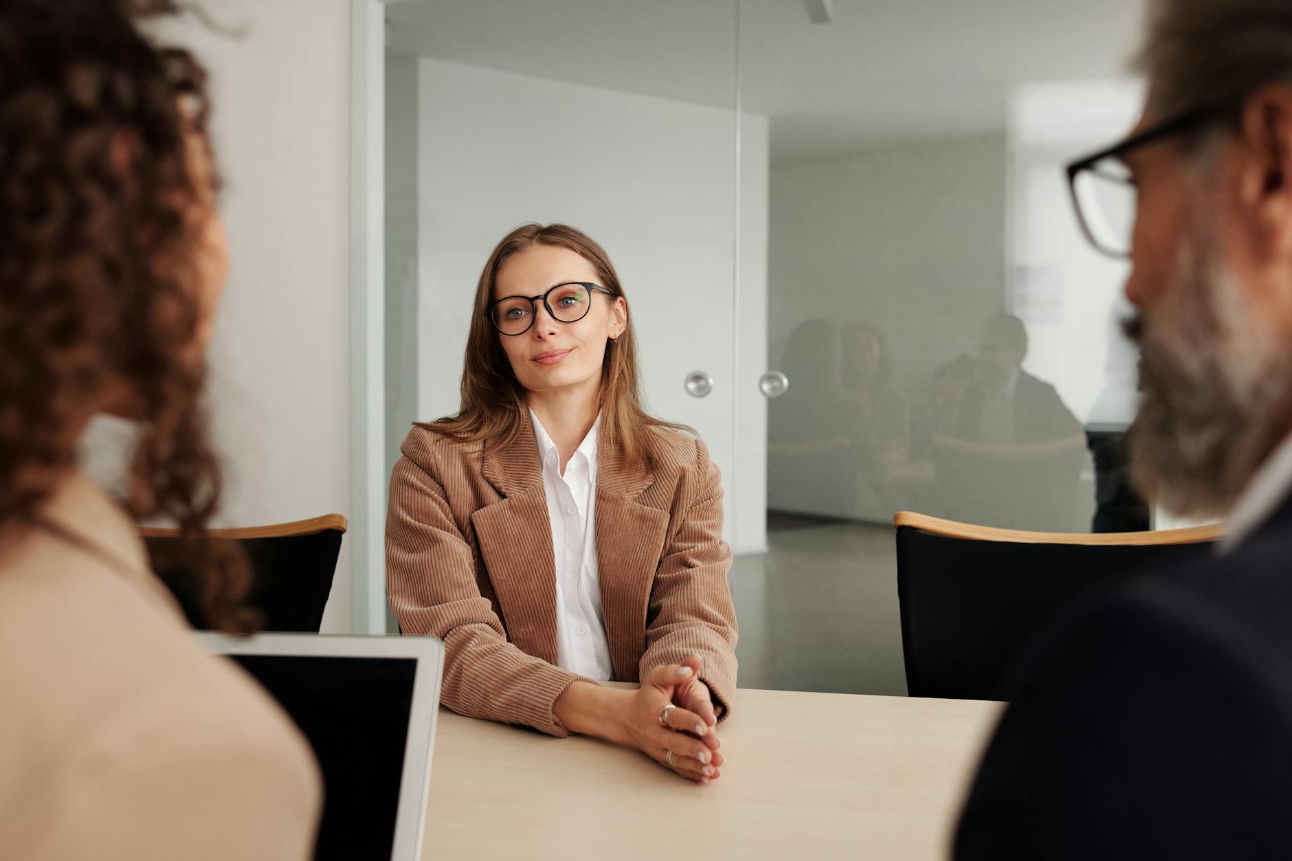 Two people in a professional office setting during a job interview