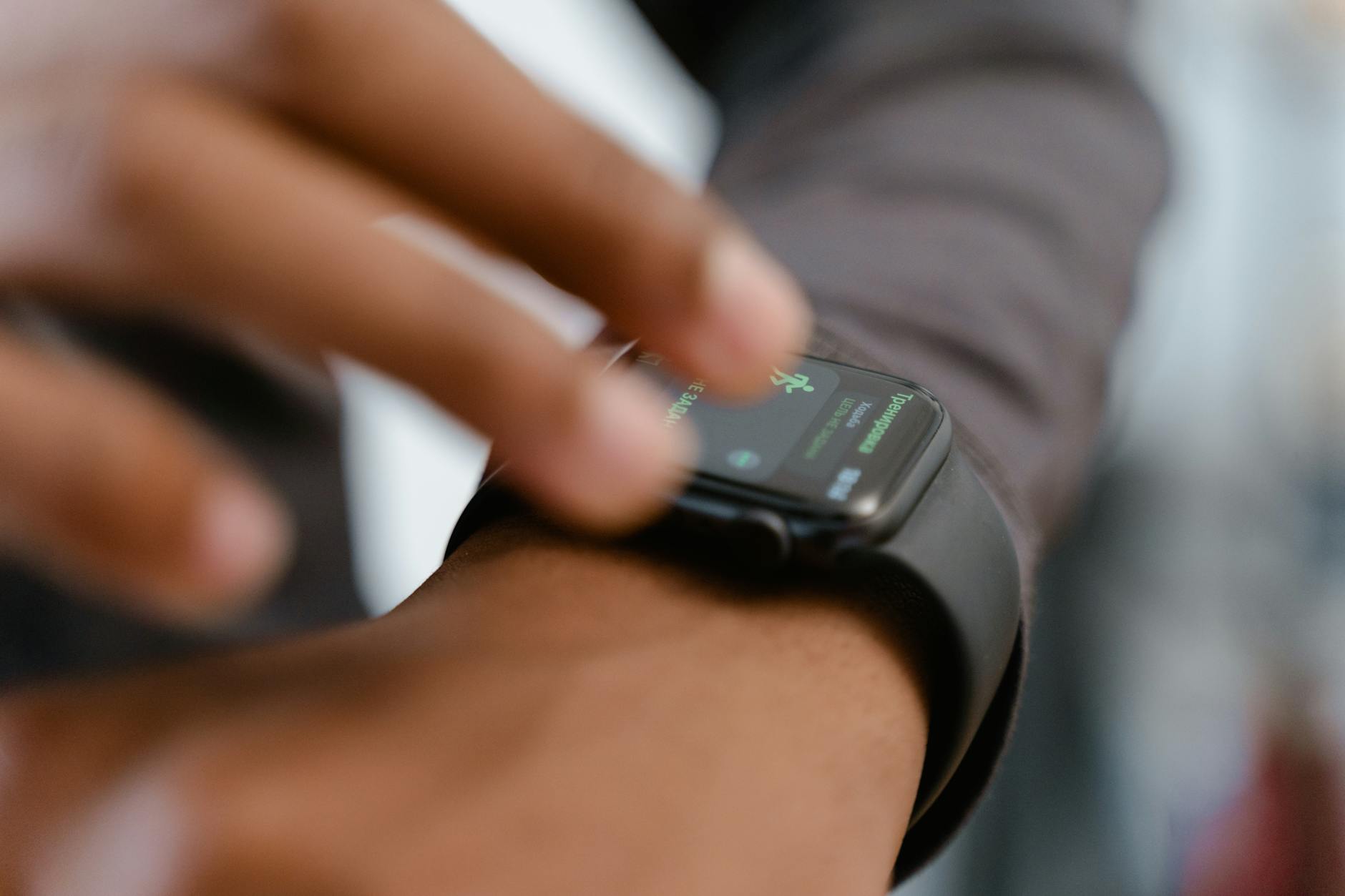 Person wearing a modern smartwatch checking fitness data on their wrist