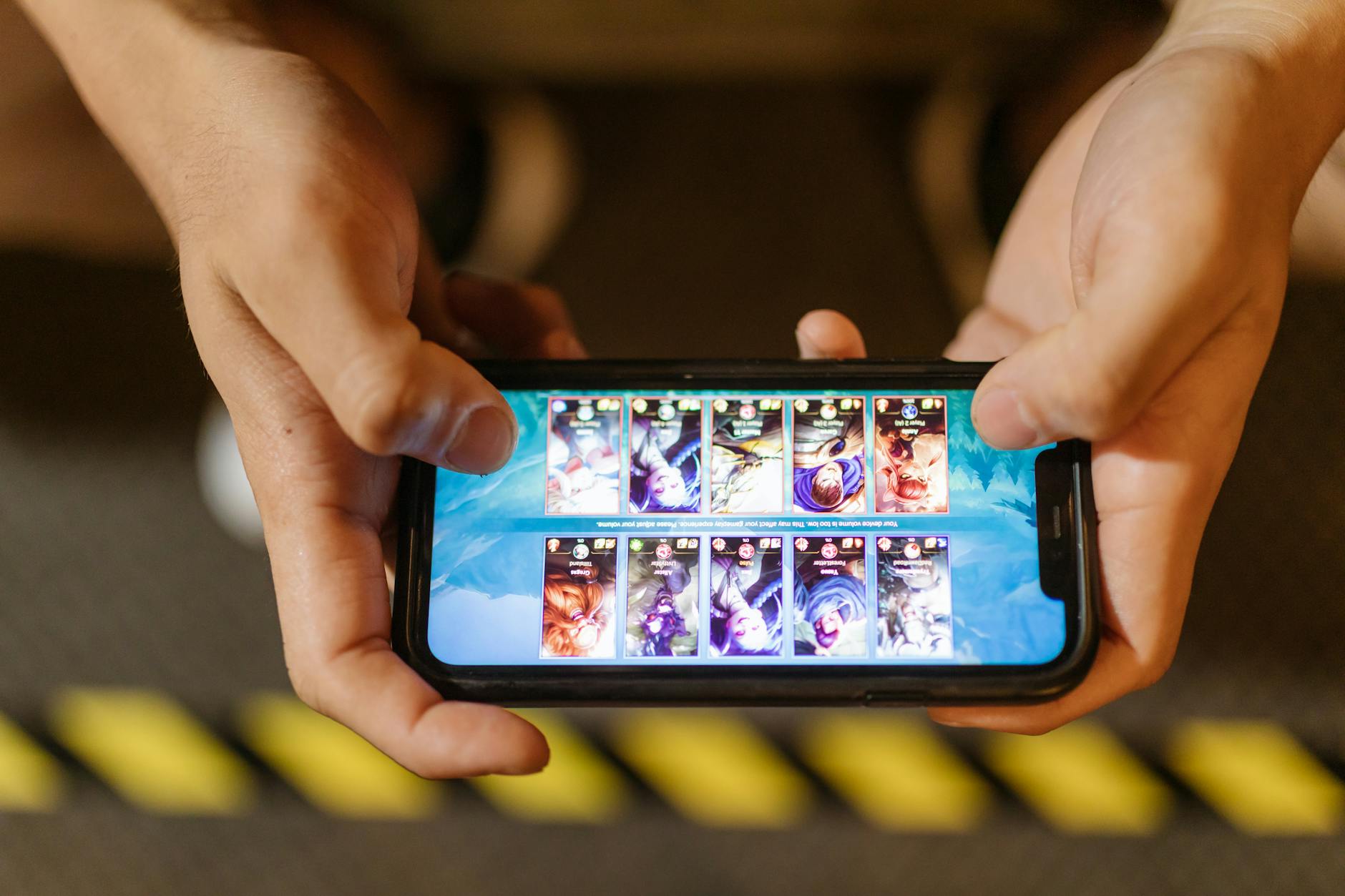 Person playing word puzzle game on smartphone screen