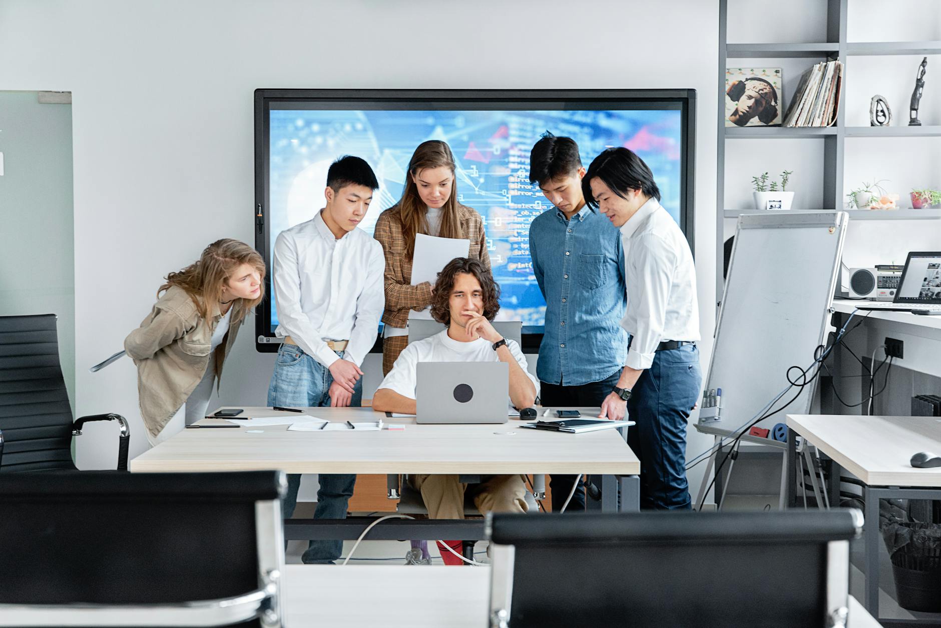 Software development team collaborating in modern office environment