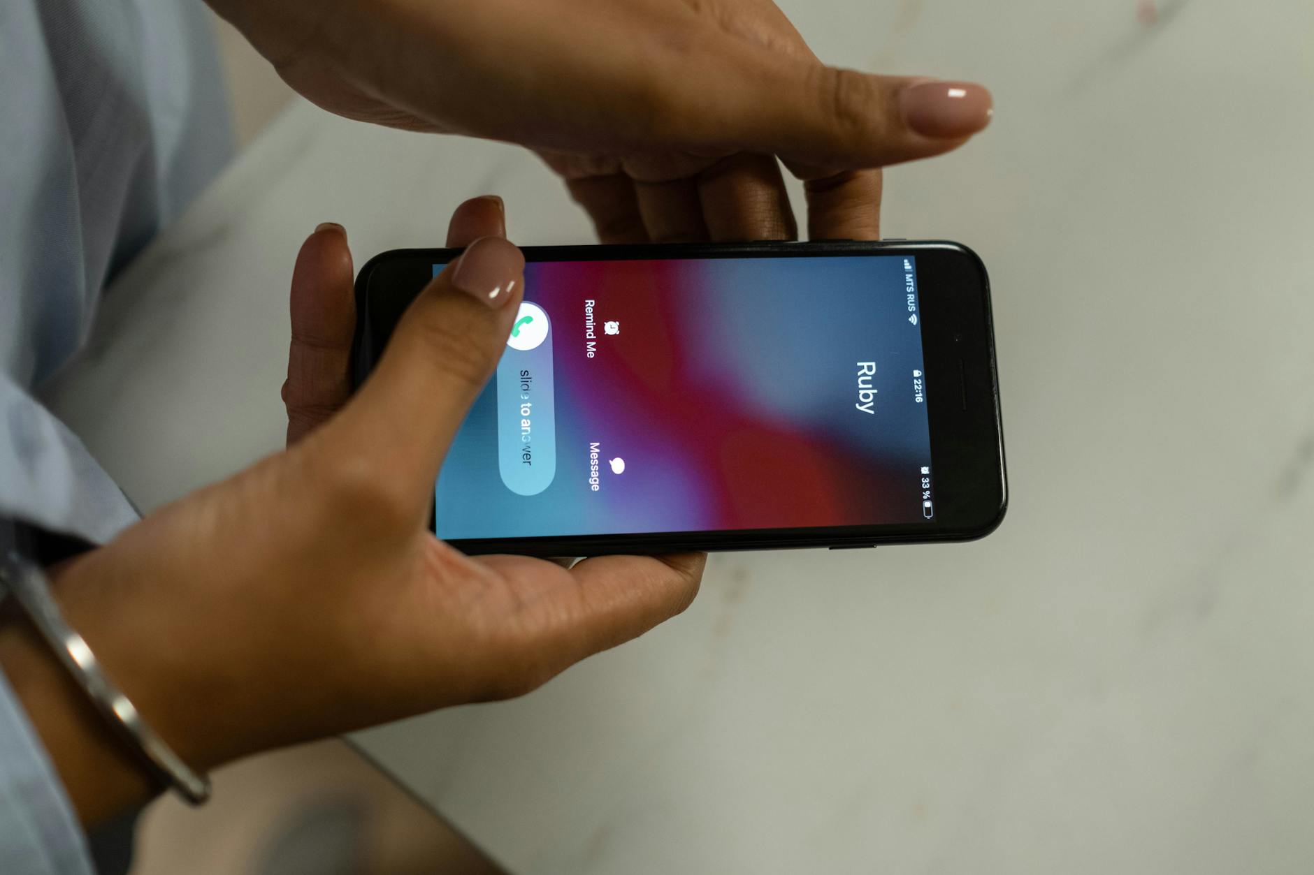 Hand holding smartphone receiving incoming call