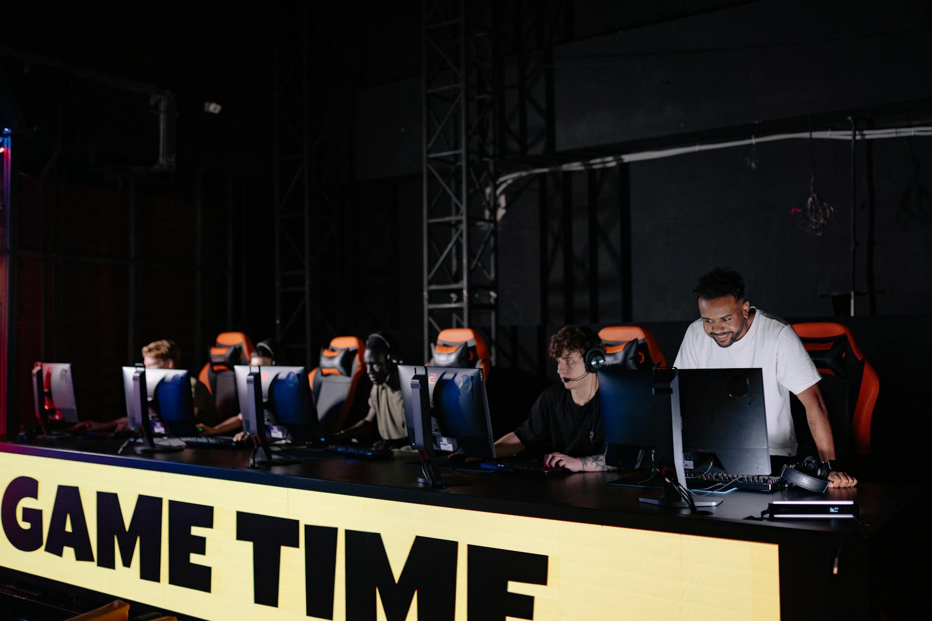 Professional esports players competing at gaming stations during tournament event