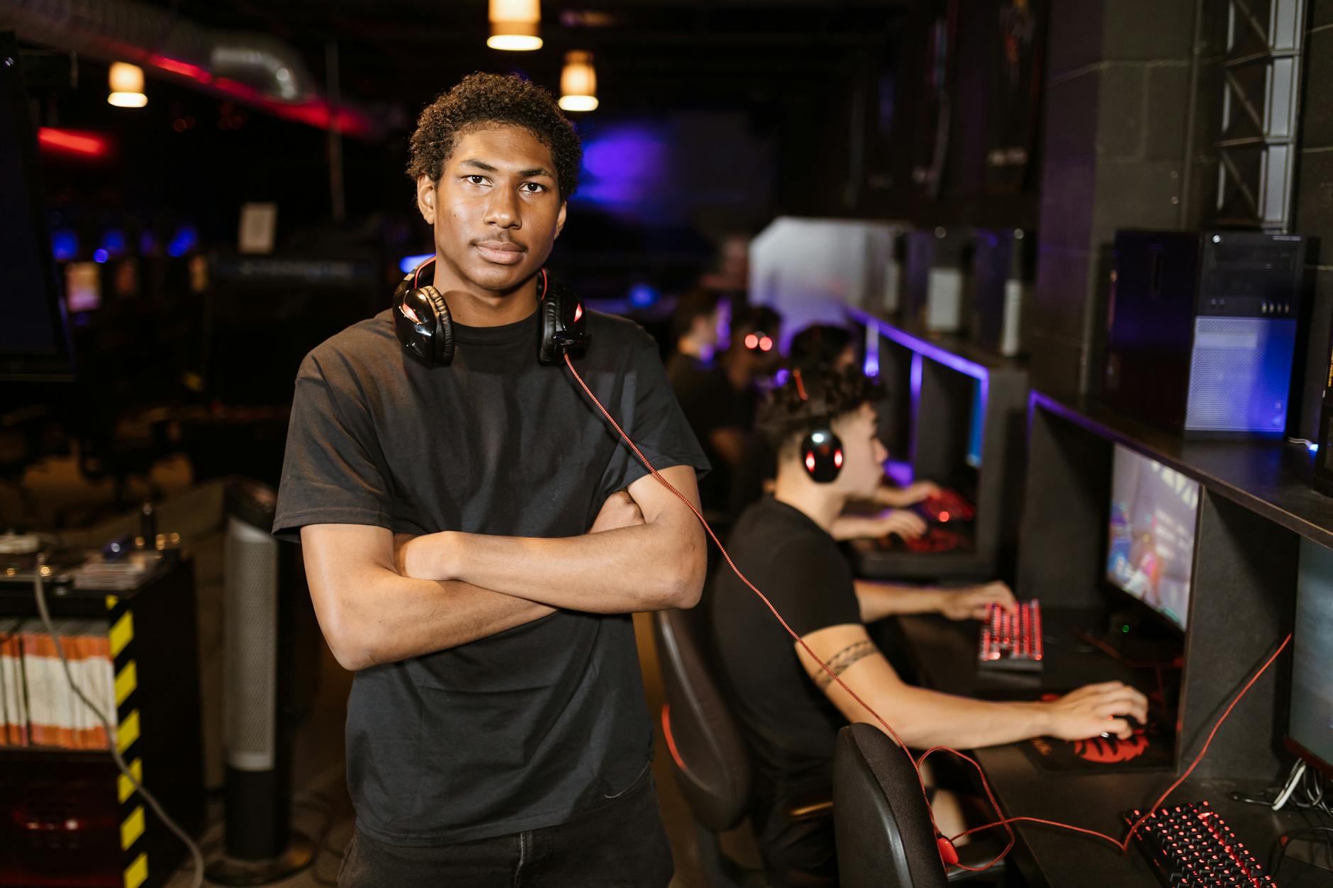 Solo game developer working at a desk with multiple screens showing game design software
