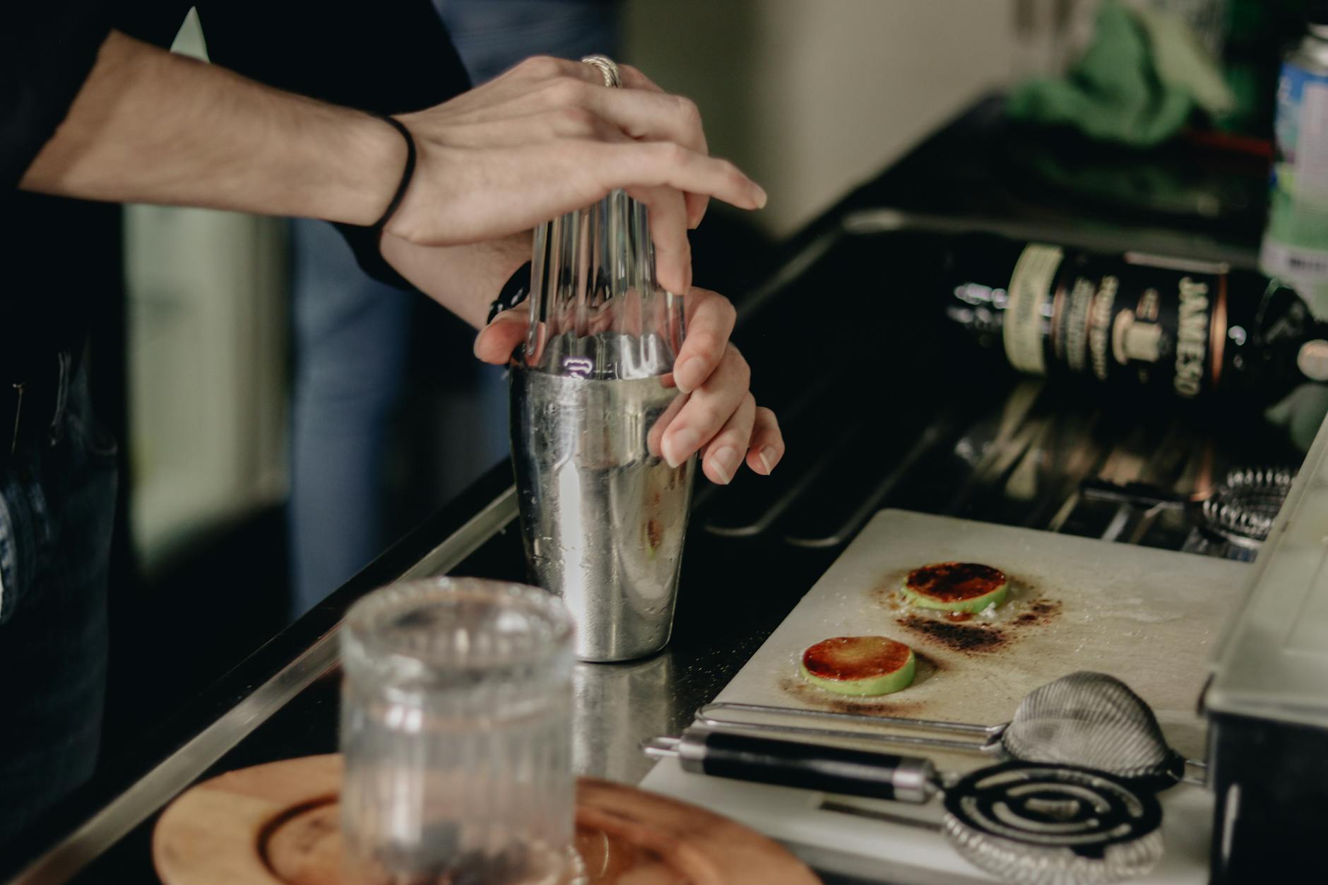 A freshly poured cocktail in a glass on a wooden surface