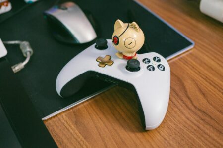 PlayStation’s wireless fight stick and new gaming monitor arrive in August A gaming peripheral setup on a desk with controllers and accessories