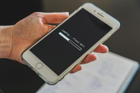 Siri AI for iPhones and iPads will be delayed indefinitely in the EU Person holding an iPhone displaying a software update screen