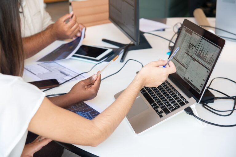 Anthropic’s latest feud with the Trump admin may actually help it, sales data suggests Business professionals reviewing AI software spending data on laptops in a modern office