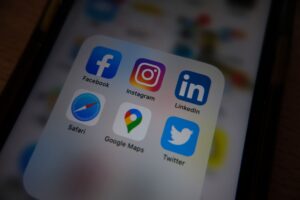 Zuckerberg Orders Meta to Build Its Own Prediction Market A smartphone displaying a social media feed on a desk