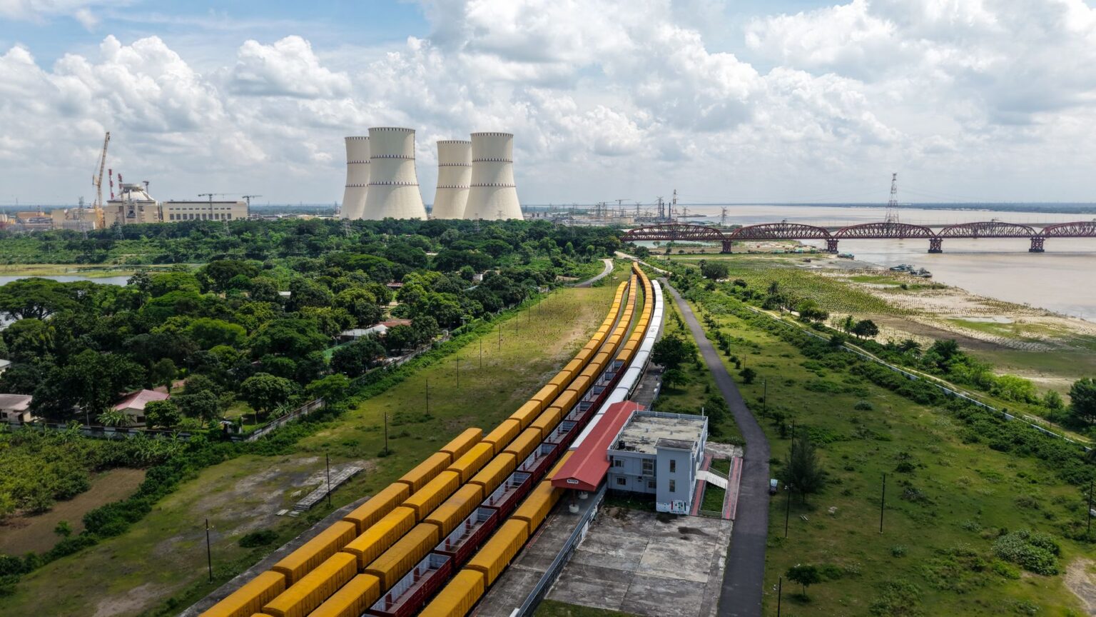 Nuclear power plant cooling towers beside a river on a hot summer day
