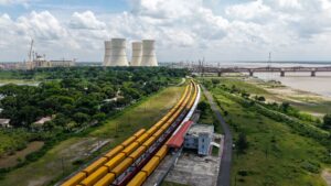 Nuclear power plant cooling towers beside a river on a hot summer day