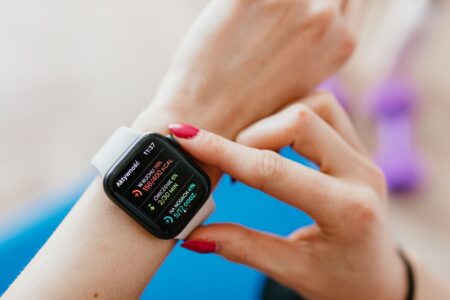 Person checking a smartwatch during a workout session at home