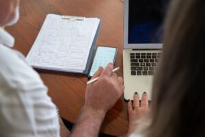 Calling AI Agents Employees Makes Human Workers Worse at Their Jobs Manager reviewing work on a computer screen in a modern office setting