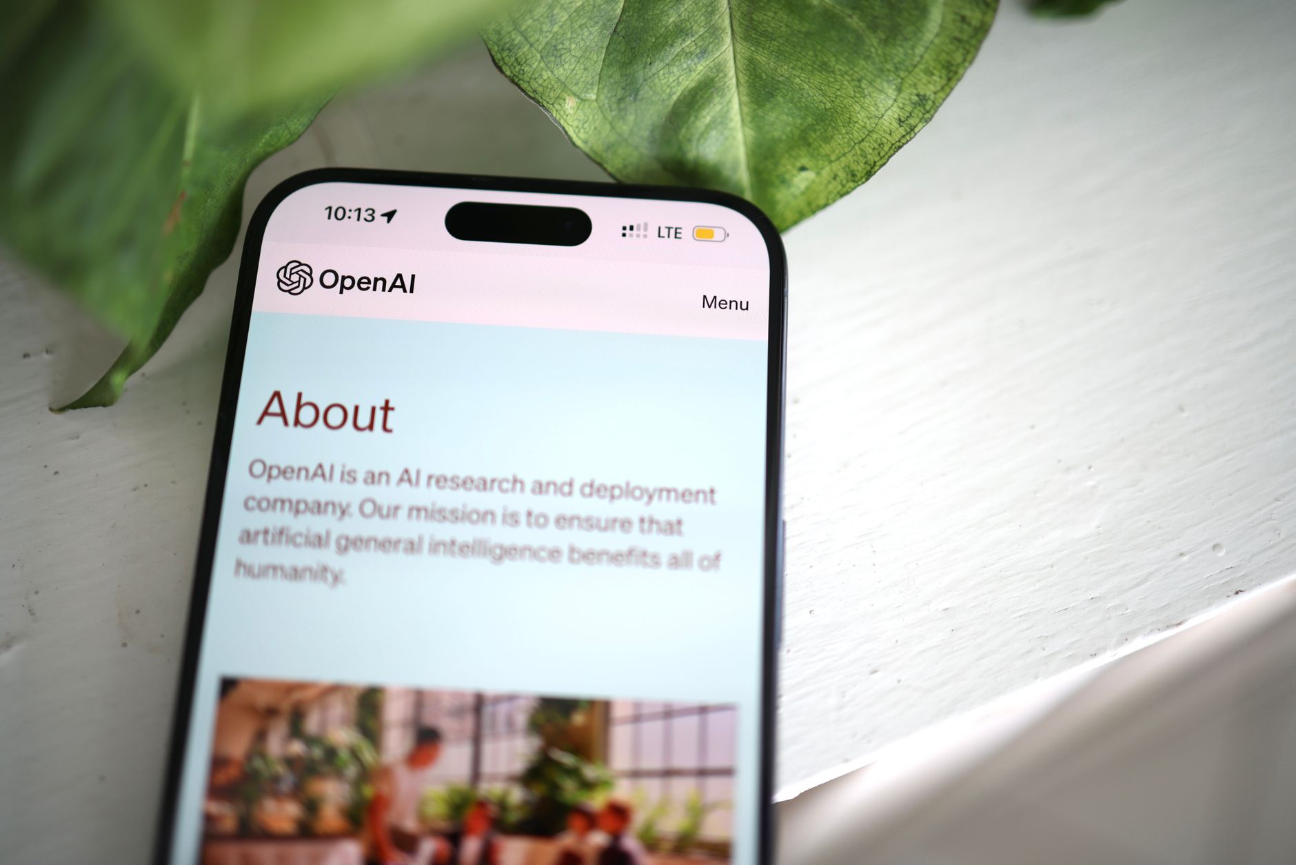 Person using a smartphone with an AI assistant interface on screen