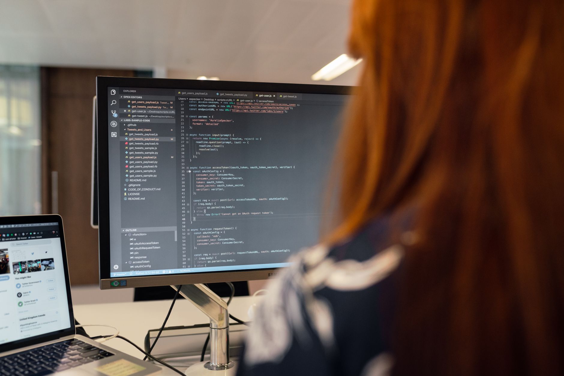 Developer writing code on a laptop screen during software rebuild project