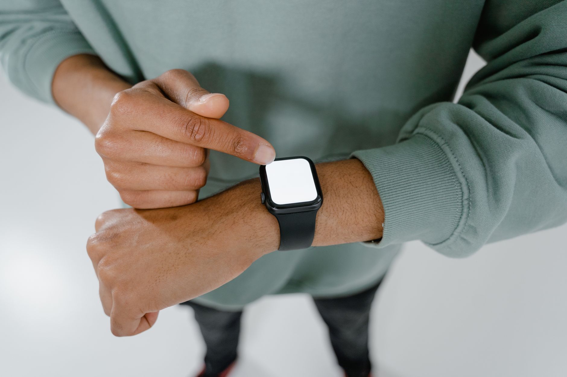 Person wearing a smartwatch showing health tracking data on the screen