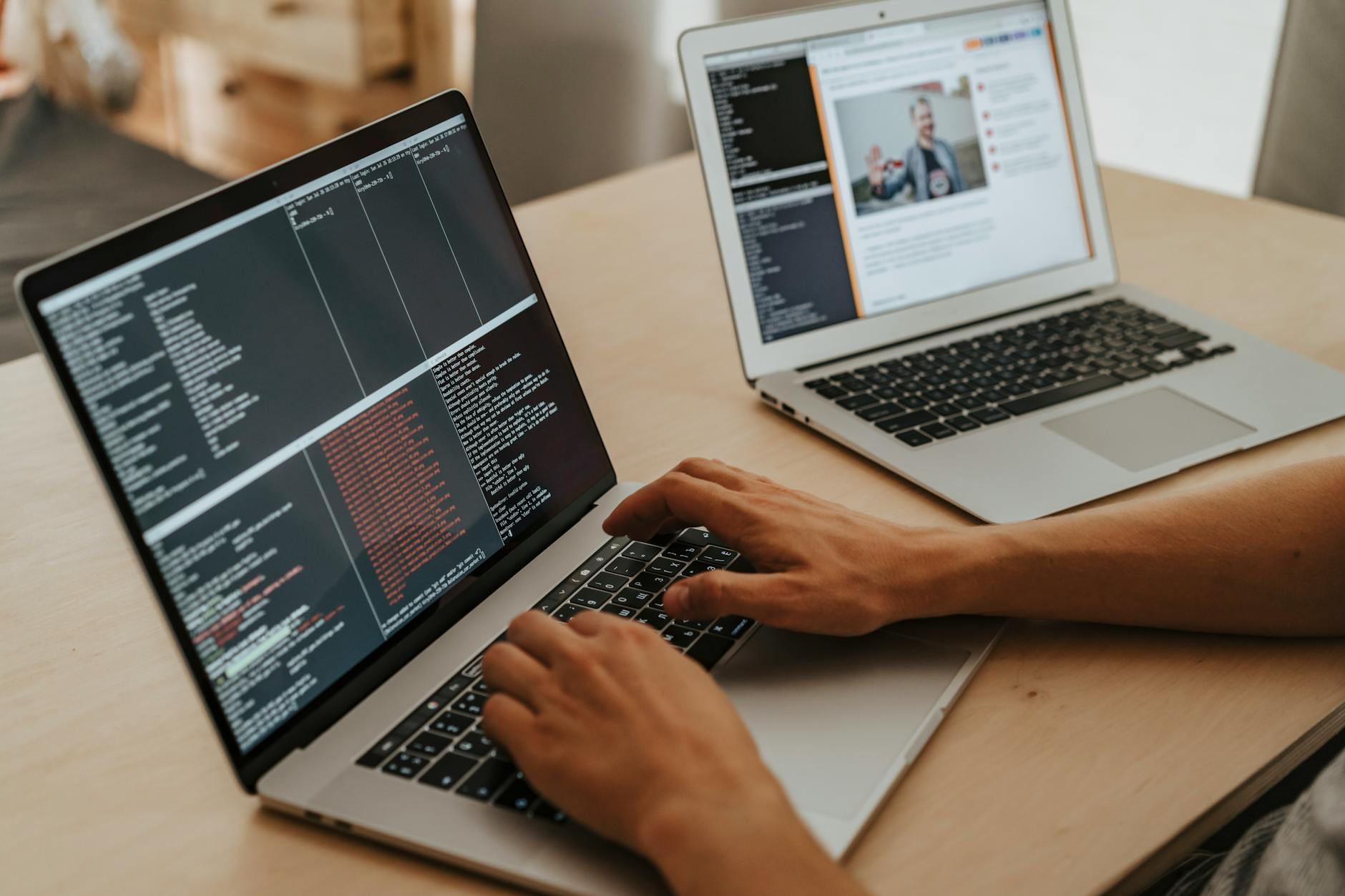 Developer working on a laptop reviewing software code and interface designs