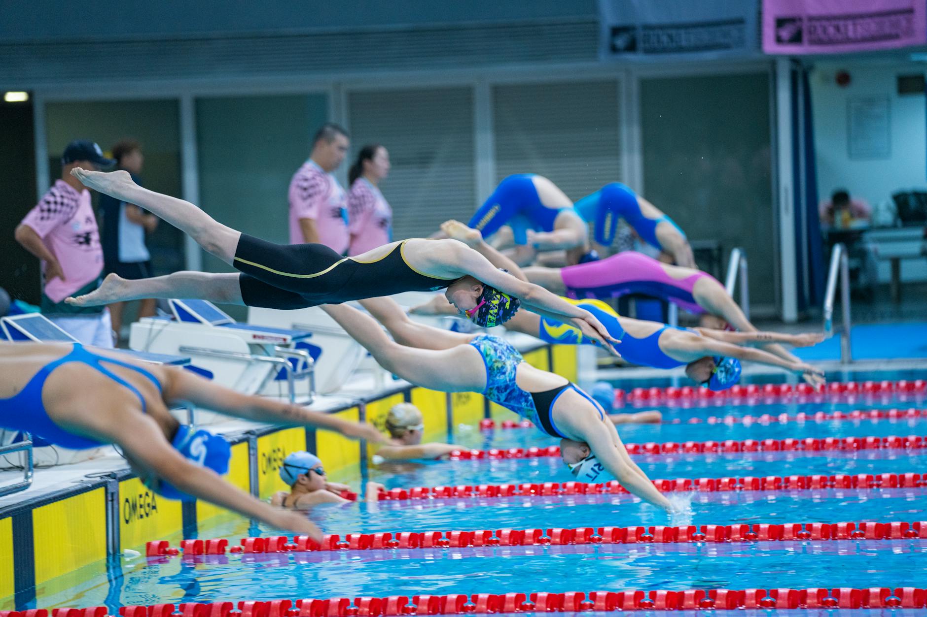Competitive swimmers racing in an Olympic-length pool during a meet
