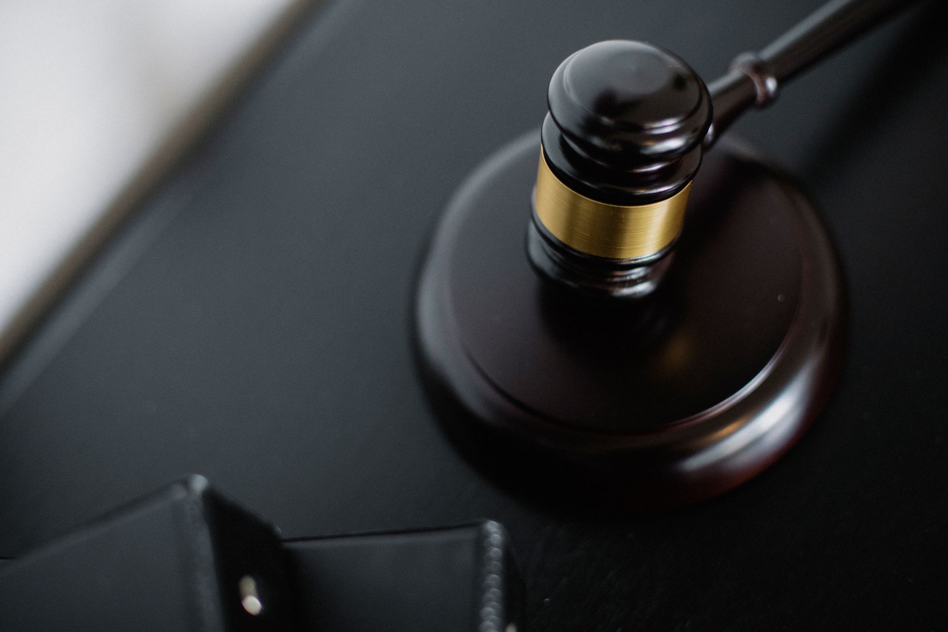 Inside a courtroom with wooden benches and legal documents on a table