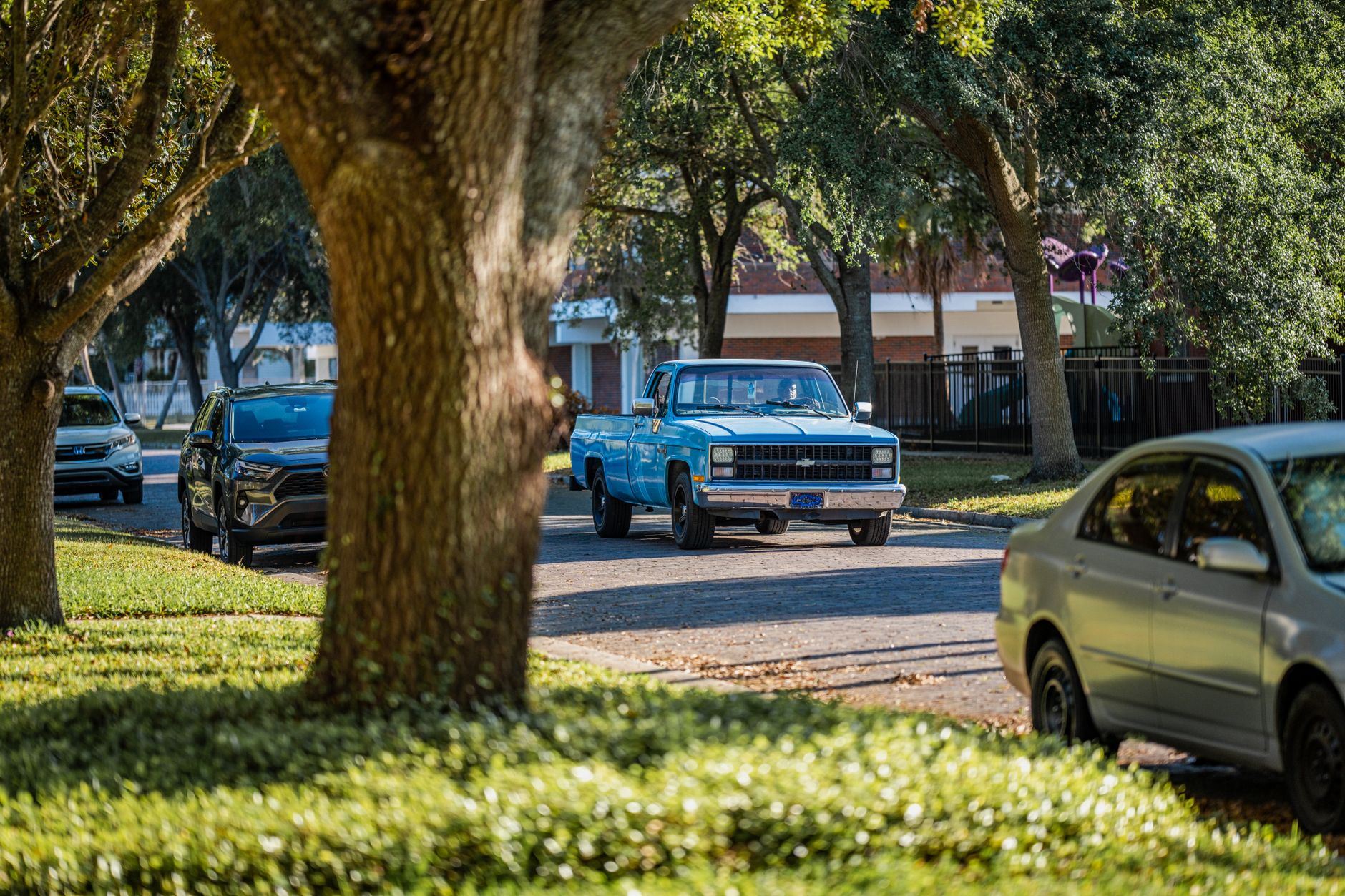 A passenger waiting at a city curb for a rideshare pickup
