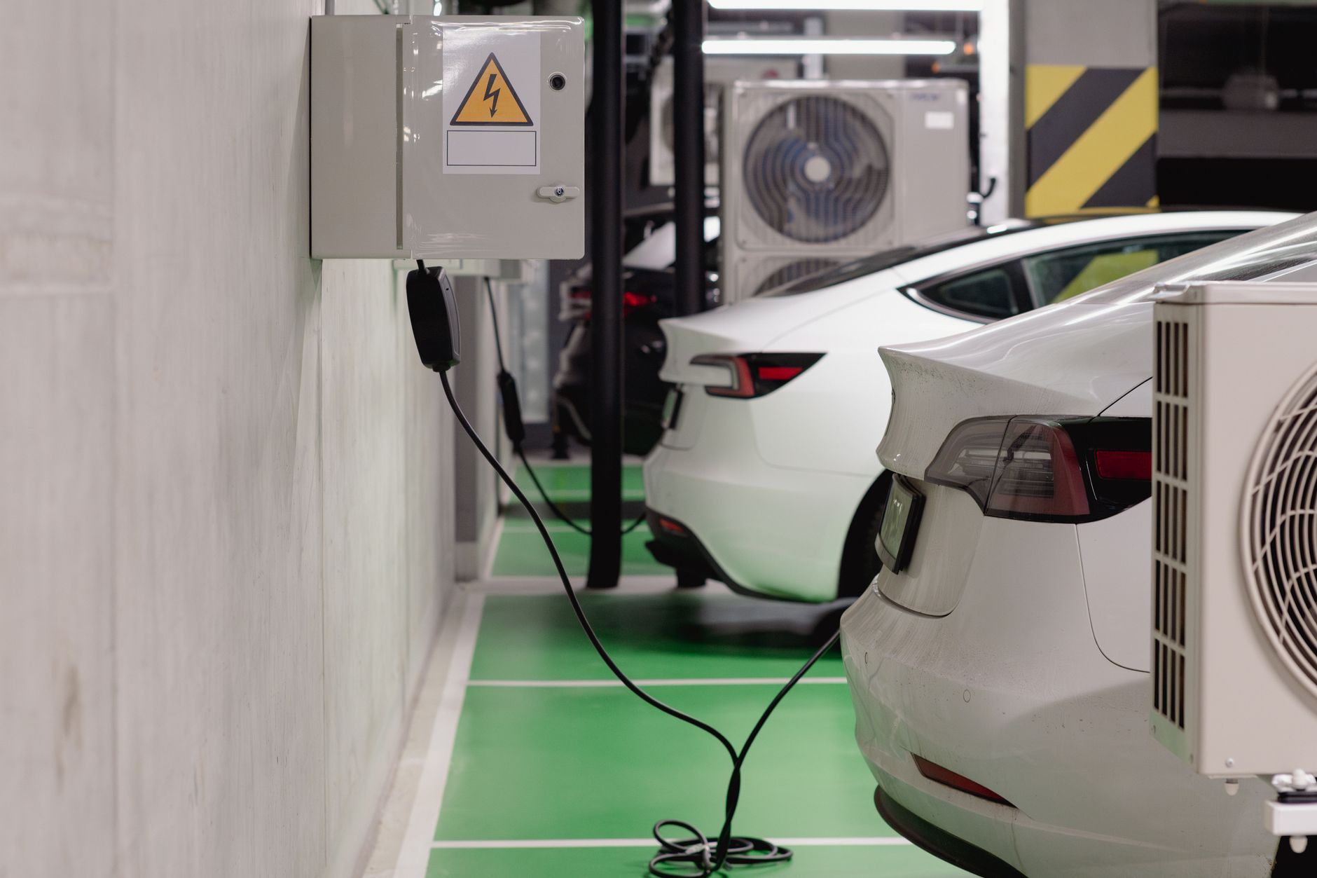 Electric vehicle plugged into a charging station representing EV market growth
