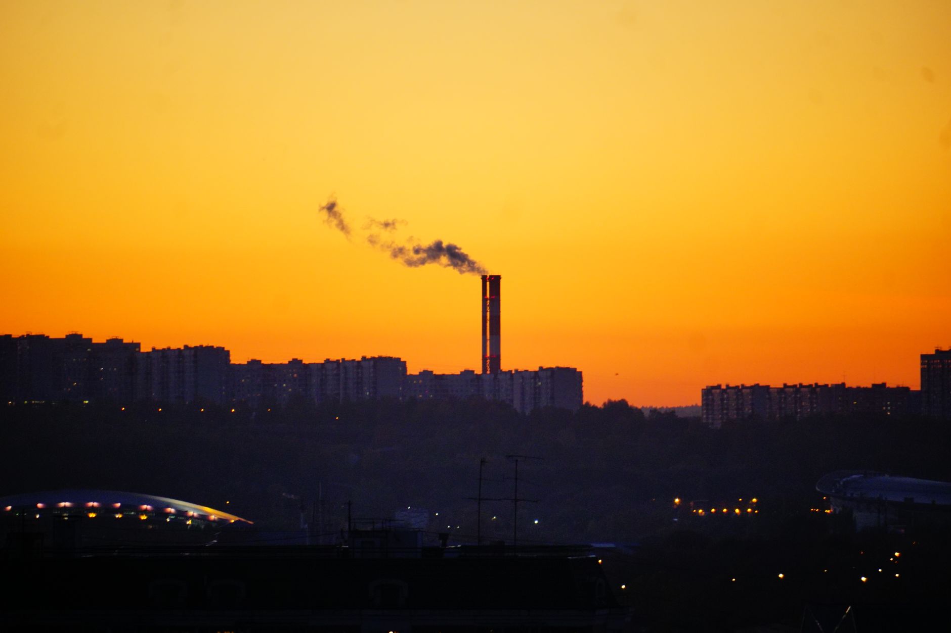 Smoke or haze over a residential neighborhood illustrating environmental pollution concerns