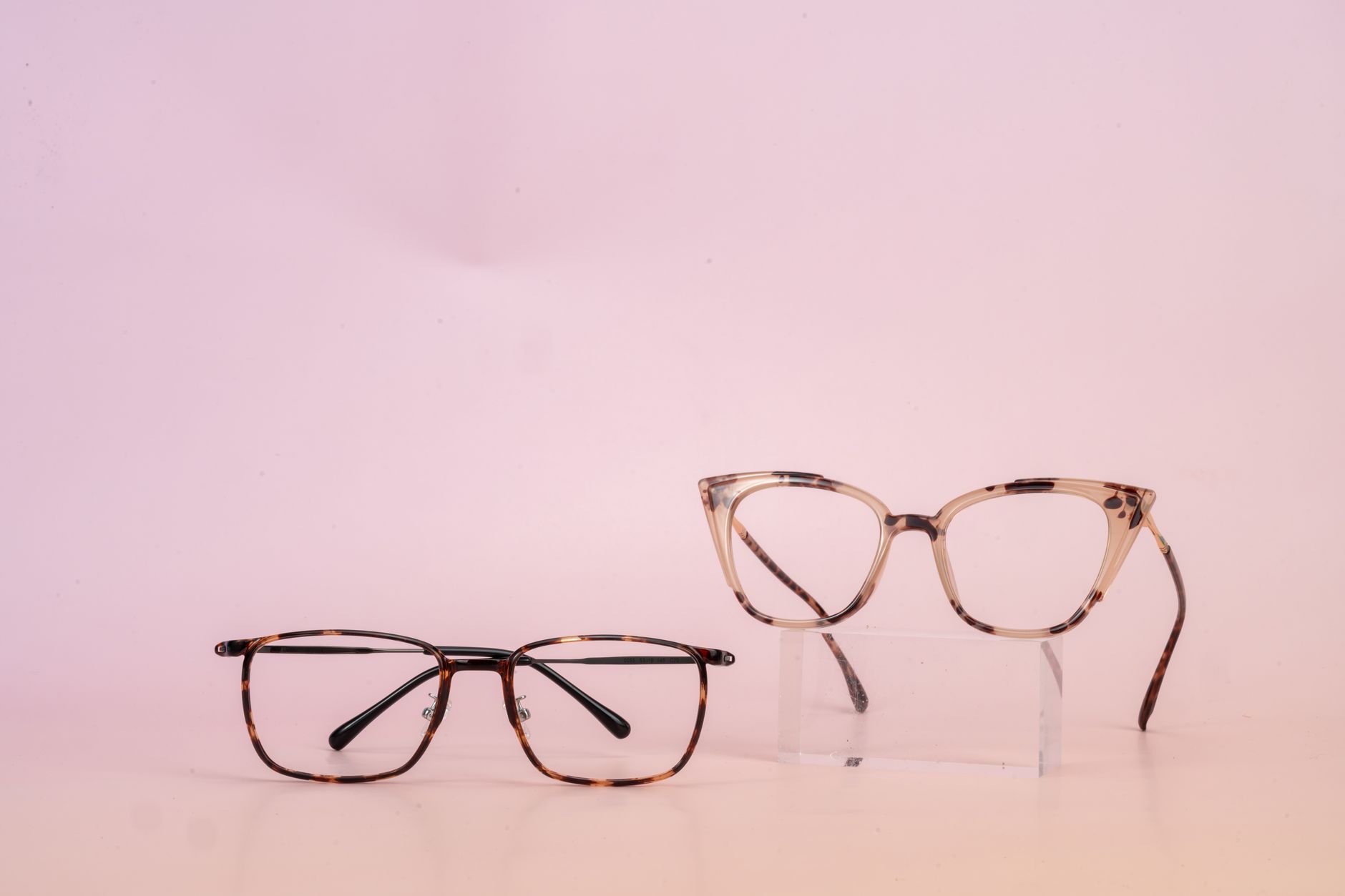 Designer frames laid out on a clean white surface in a product studio
