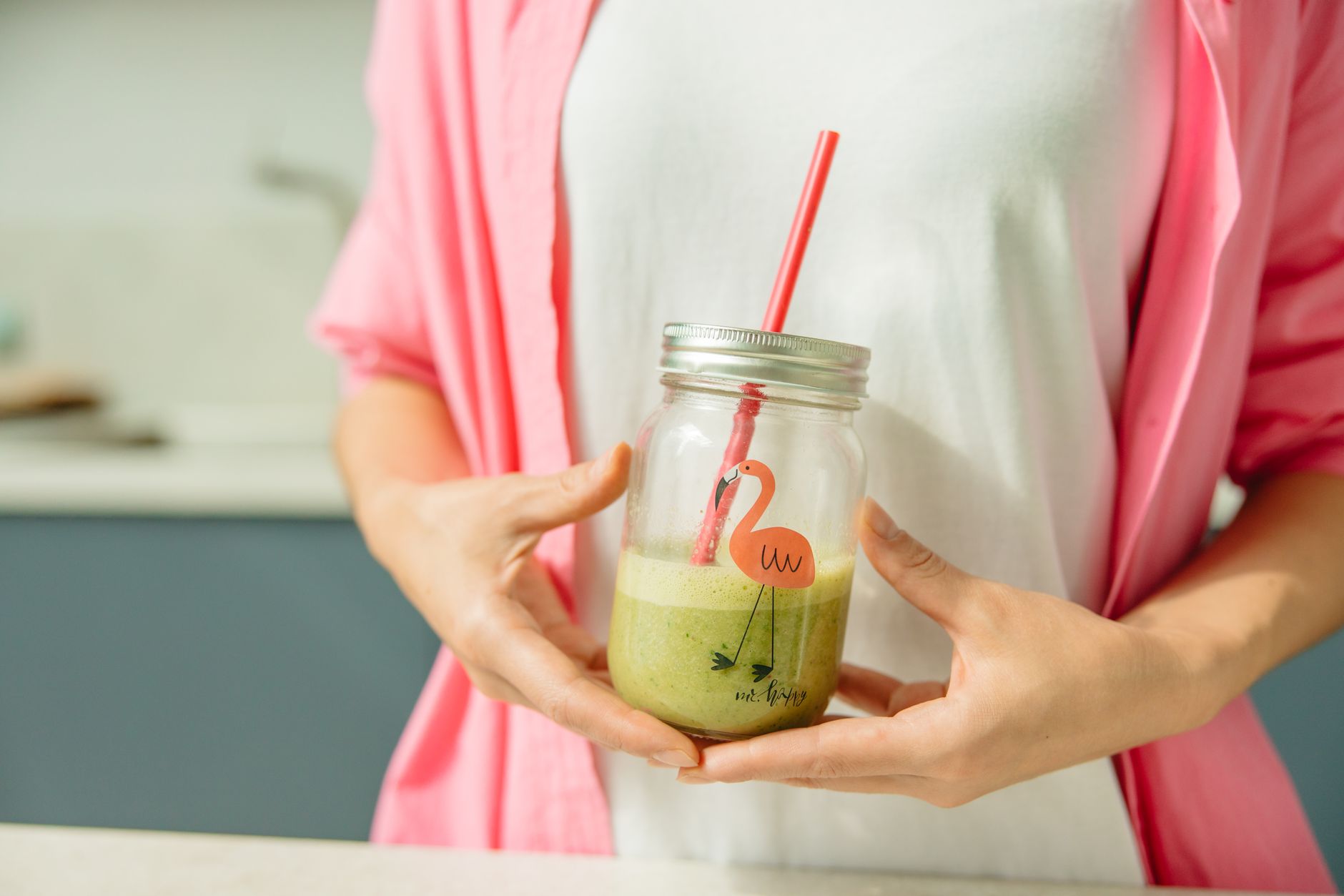 Person mixing a green smoothie drink as part of a daily nutrition routine