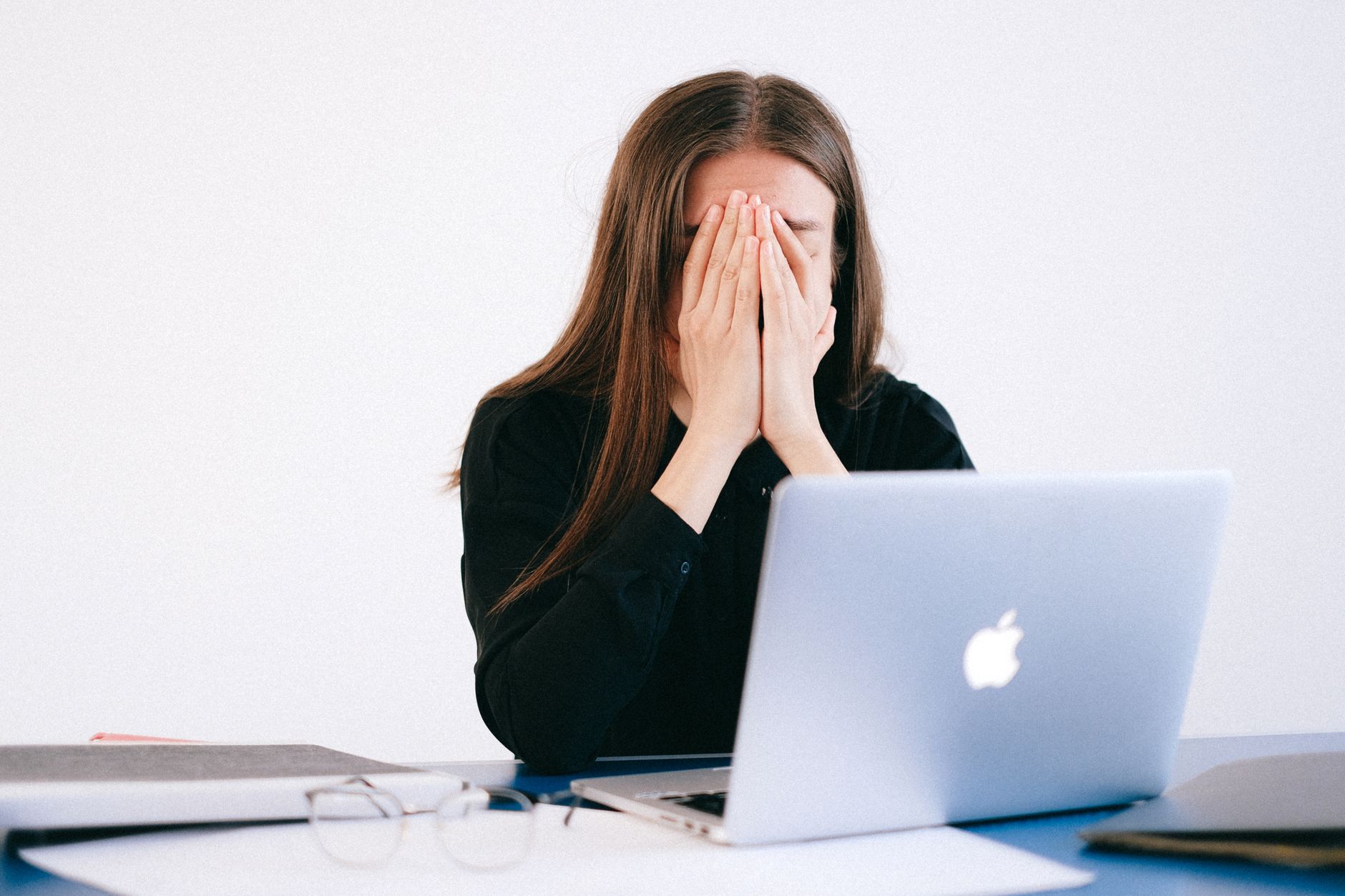 A worker sitting alone at a desk representing job displacement and unemployment