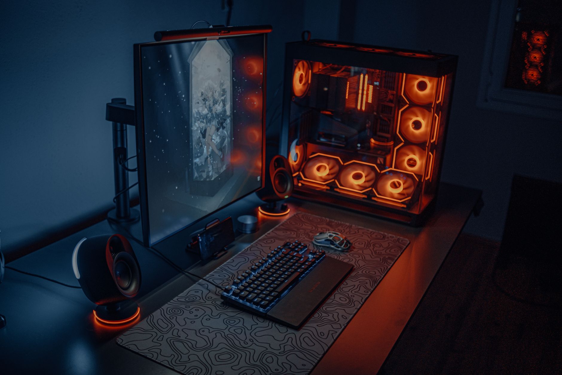 Gaming keyboard and peripherals arranged on a desktop workspace