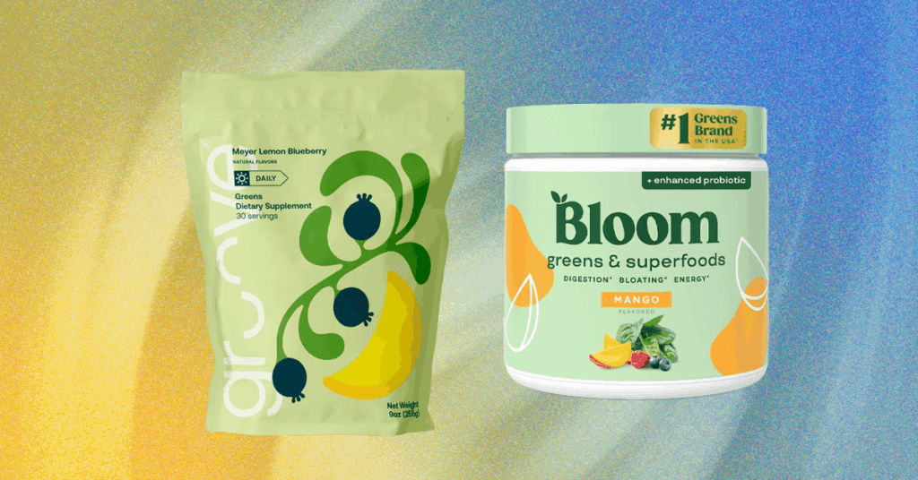A scoop of green superfood powder next to a glass of water on a kitchen counter