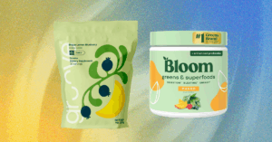 Bloom Nutrition Leads the Pack Among Best Greens Powders A scoop of green superfood powder next to a glass of water on a kitchen counter