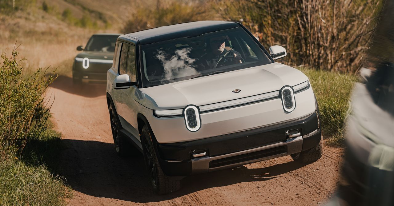 Modern electric SUV driving on an open road representing Rivian's R2 launch strategy