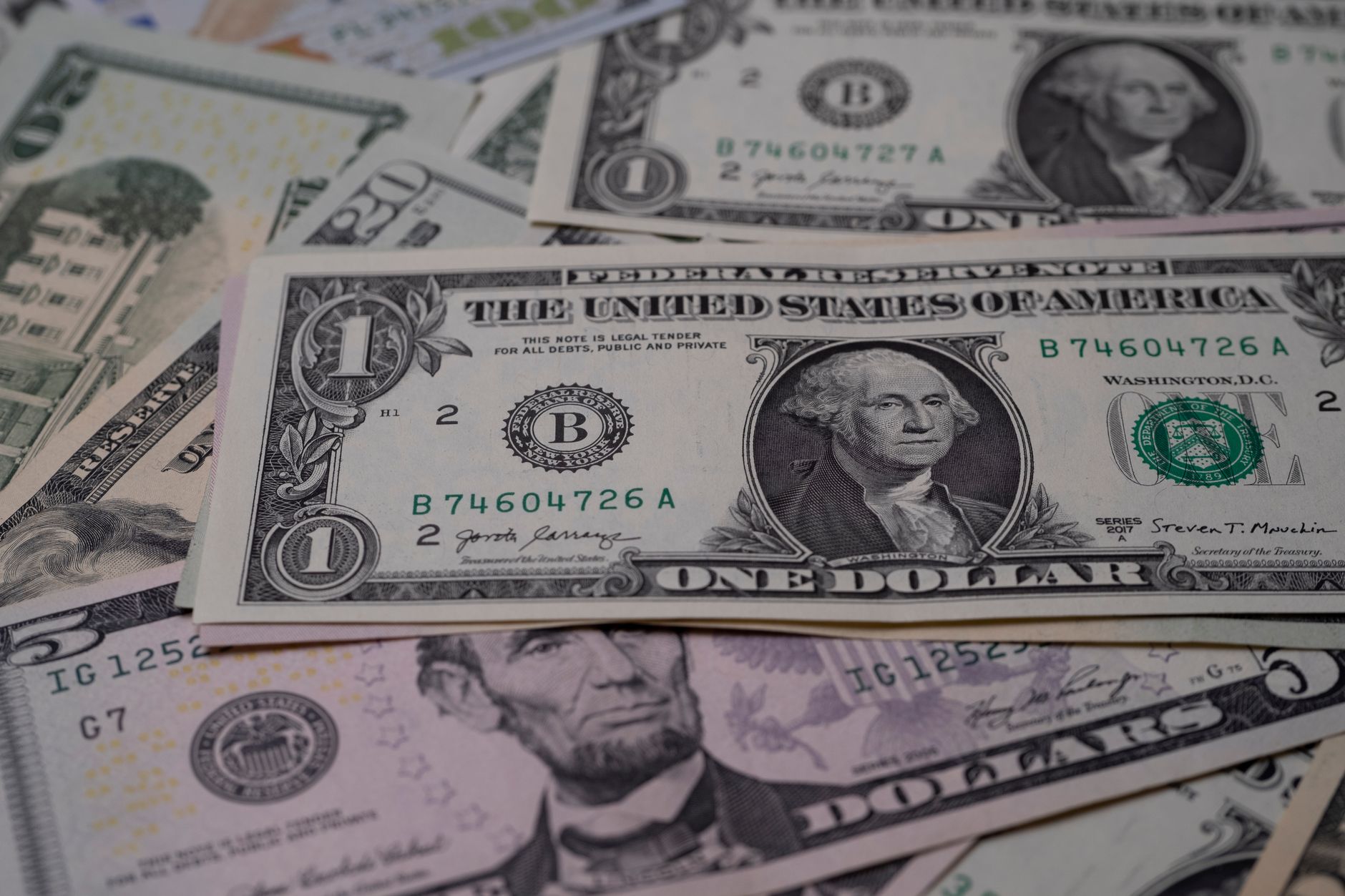 Stack of US dollar bills representing government financial stakes and AI dividend proposals