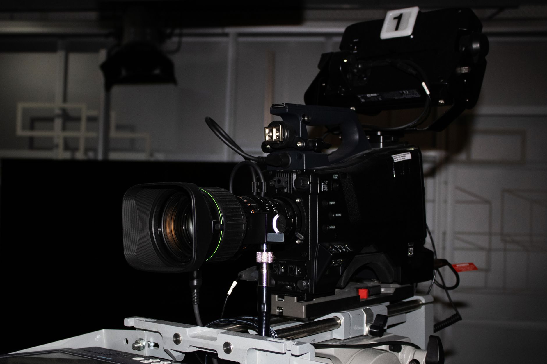 A broadcast television studio with production equipment and screens