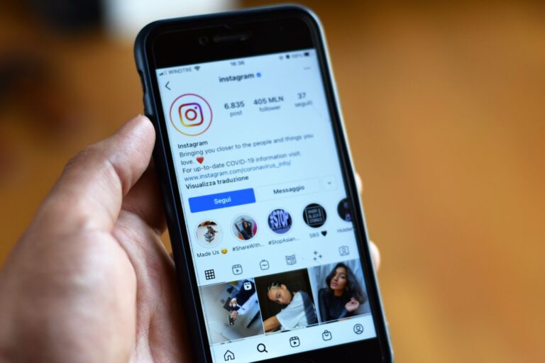 Person scrolling through a public Instagram profile on a smartphone