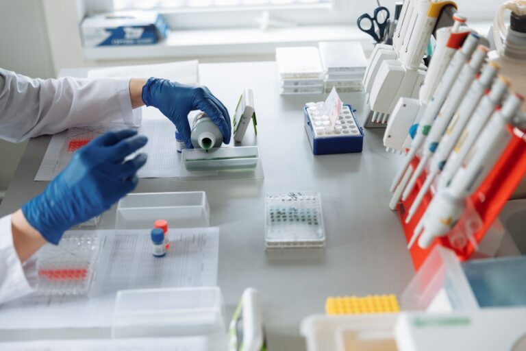 Reed Jobs Focuses on Curing Cancer, Not His Famous Last Name Researcher working in a modern biotech laboratory with scientific equipment