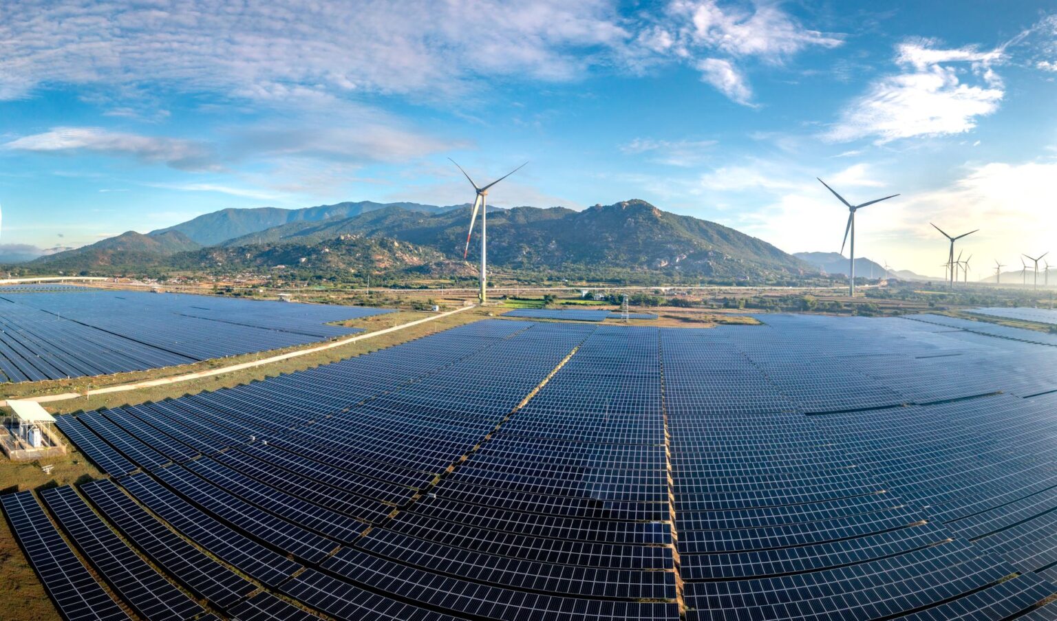Google Buys Entire Arkansas Solar Farm Output to Cover Data Center Emissions Aerial view of a large utility-scale solar farm with rows of panels under a blue sky