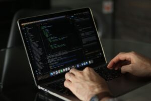 Cognition Pays Nine Figures to Make Devin Less Robotic Developer working on a laptop with code on screen