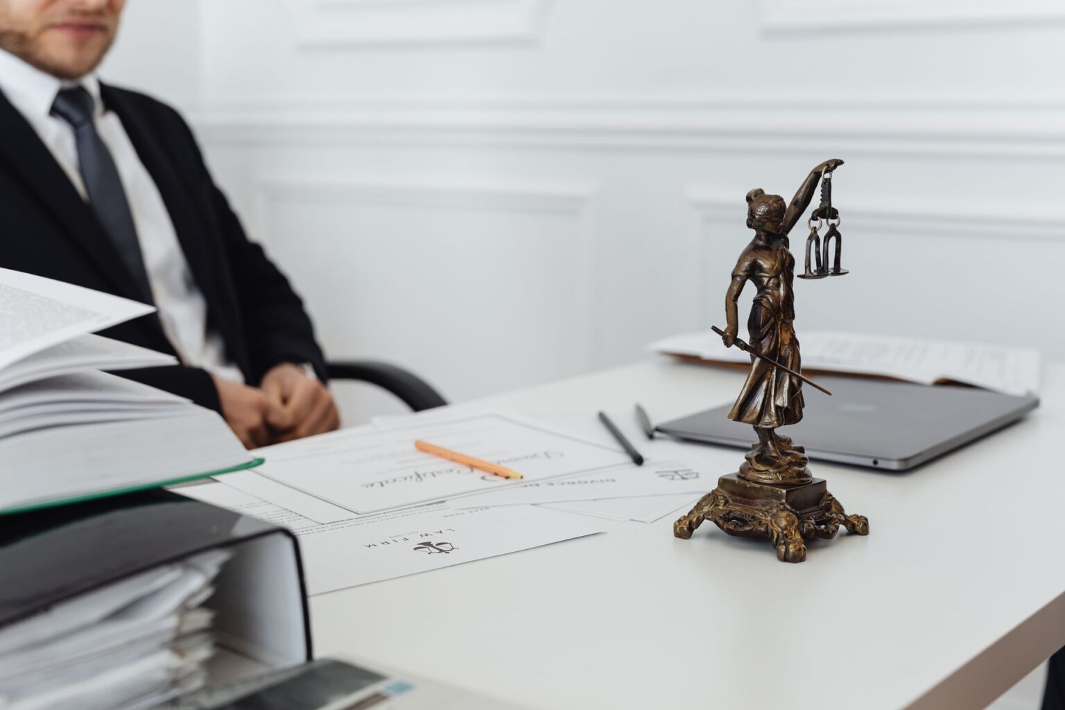 Legal documents on a courtroom table representing a corporate lawsuit settlement