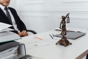 X Drops Legal Fight Against Ad Group After Two-Year Standoff Legal documents on a courtroom table representing a corporate lawsuit settlement
