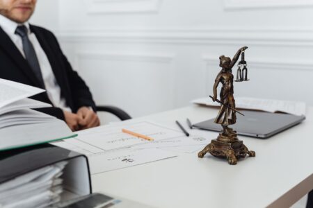 X Drops Legal Fight Against Ad Group After Two-Year Standoff Legal documents on a courtroom table representing a corporate lawsuit settlement
