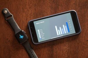 Person wearing a smartwatch displaying heart rate data on the screen