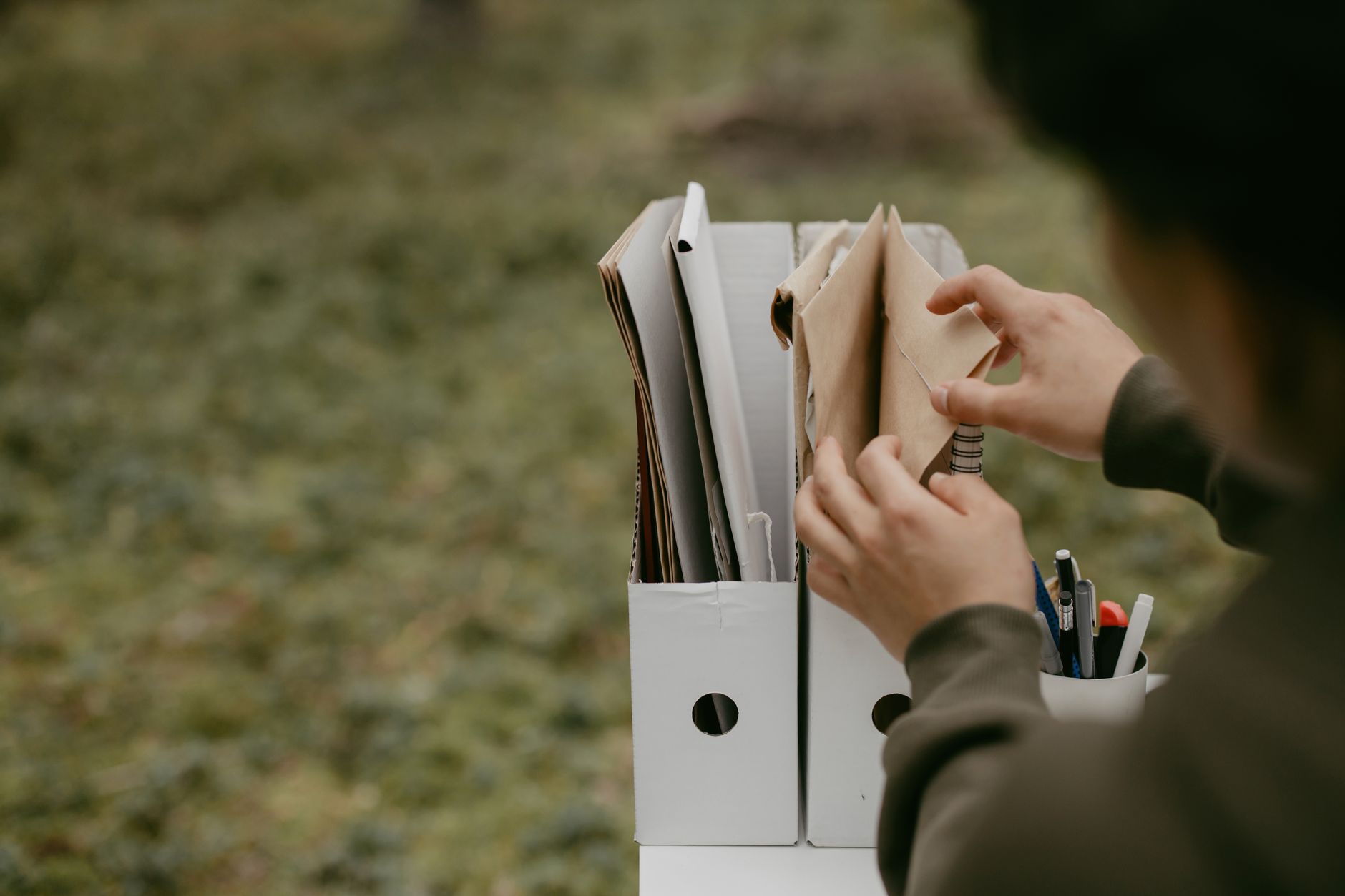 Scattered paperwork and documents representing a failed business announcement