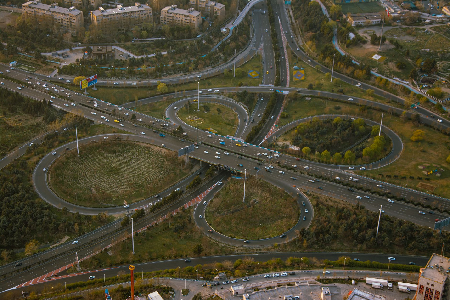 A busy city road intersection with pedestrians and vehicles