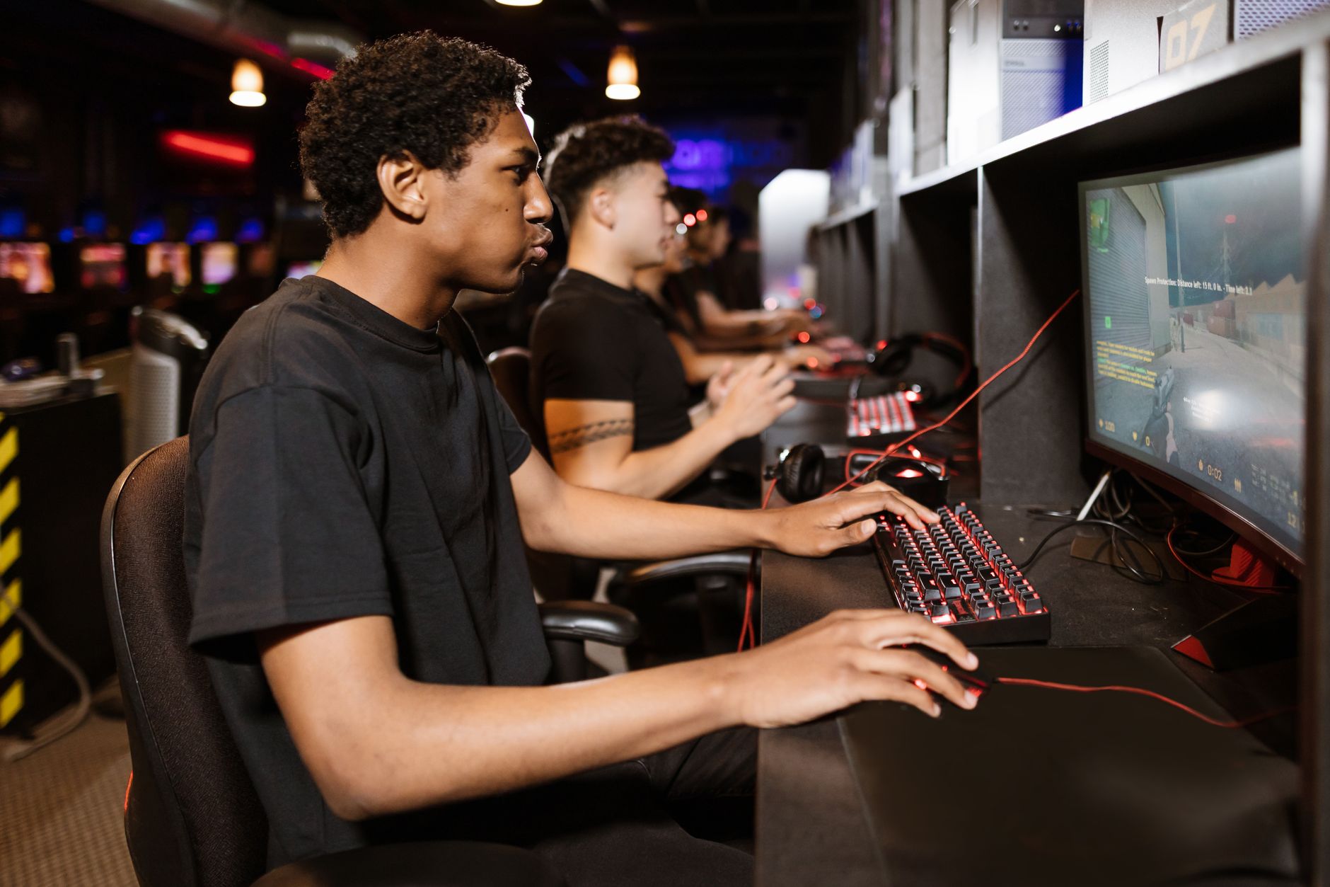 Young student using gaming peripherals at a computer workstation