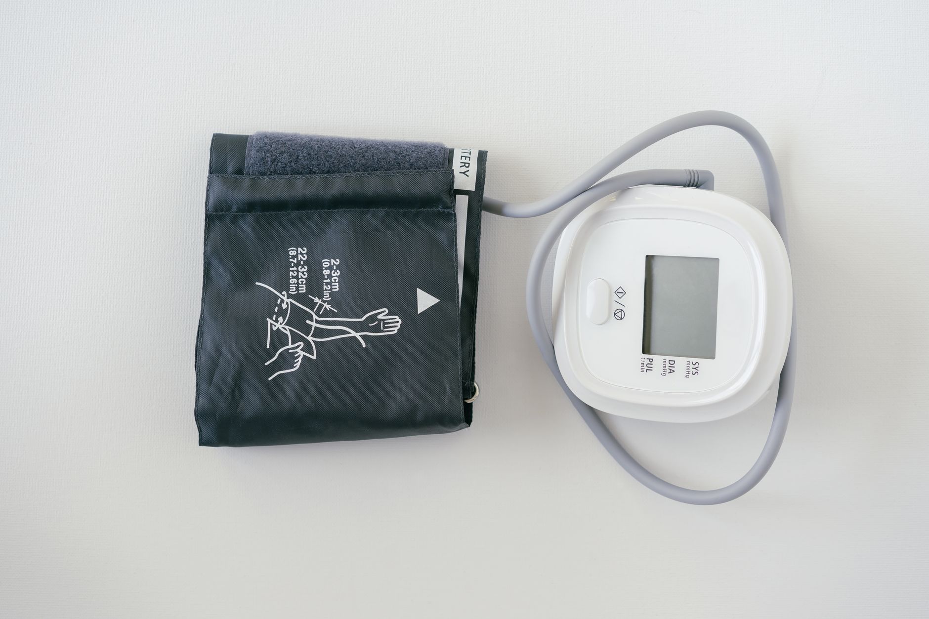 Compact handheld health monitoring device held in a person's hand