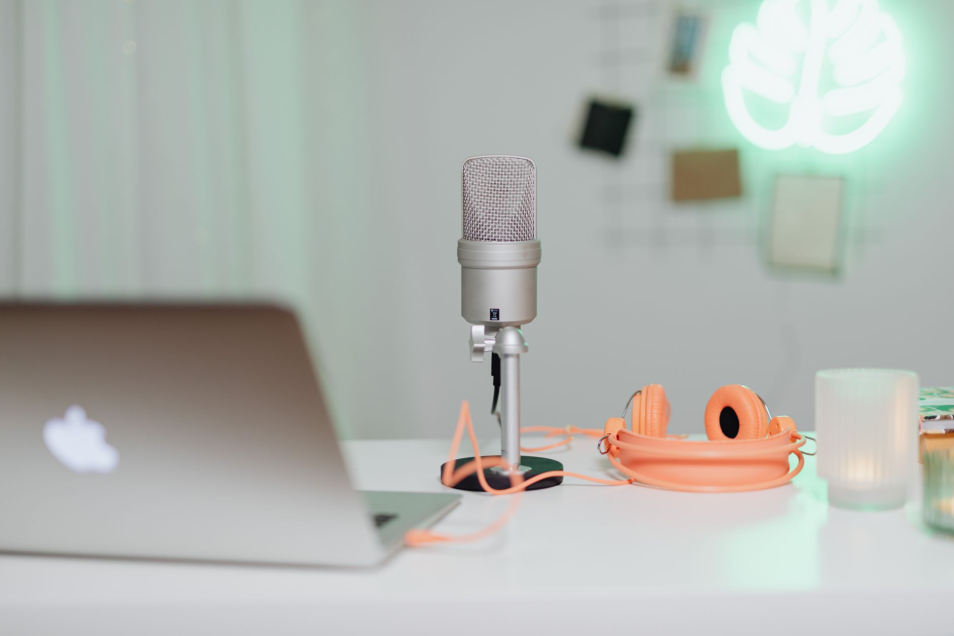A podcast recording desk with microphones and headphones in a production room