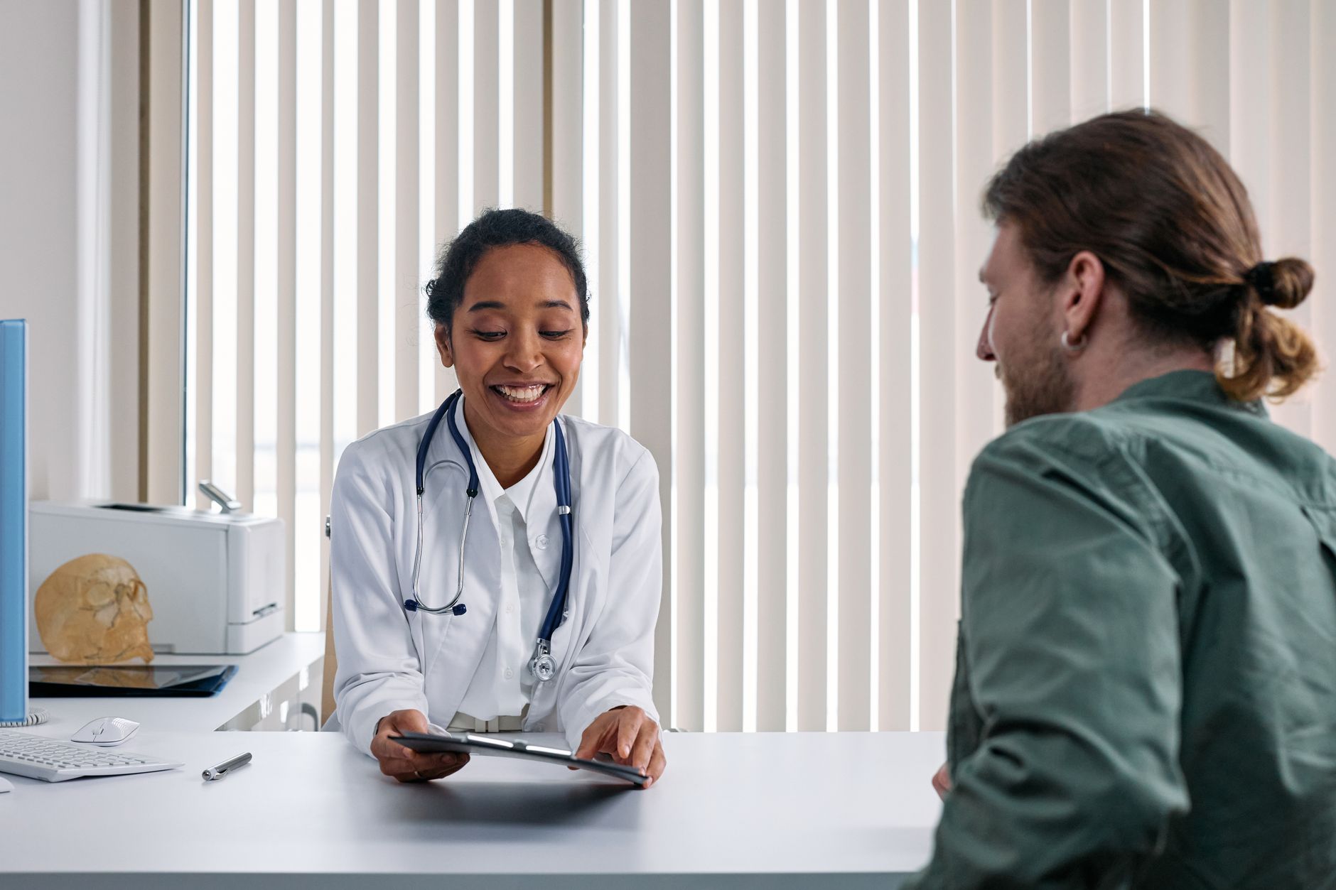 Patient showing smartwatch health data to a doctor during a consultation